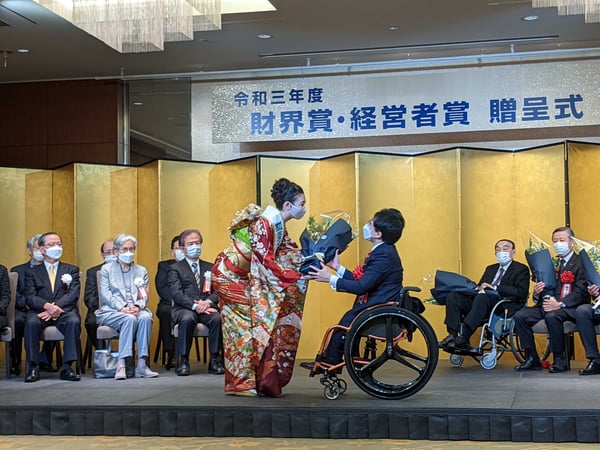 【写真】『財界賞・経営者賞』の贈呈式にて、花束を受け取る垣内の様子